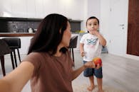 Girl in Brown T-shirt Holding Blue Ball