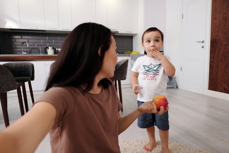 Mother And Son Eating In The Kitchen