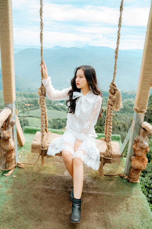 Free Stylish Asian model on swing against ridge Stock Photo
