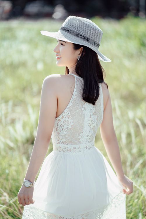 Smiling Asian woman in elegant apparel standing in field Free Stock Photo Smiling Asian woman in elegant apparel standing in field Free Stock Photo