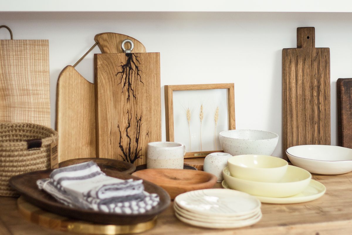 Minimalist arrangement of ceramic dishes and wooden cutting boards