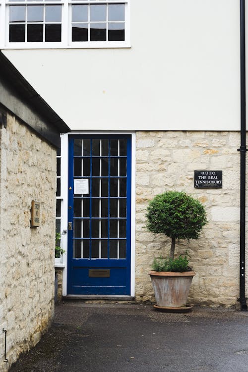 Stone building with blue door in quiet district