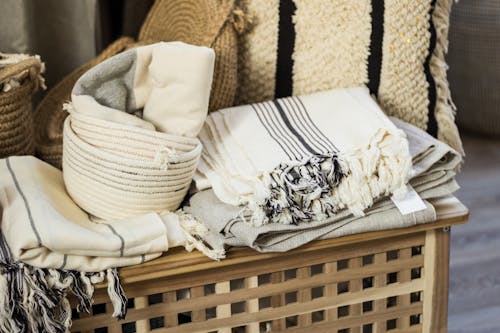 Stacked towels and plaid on wooden box