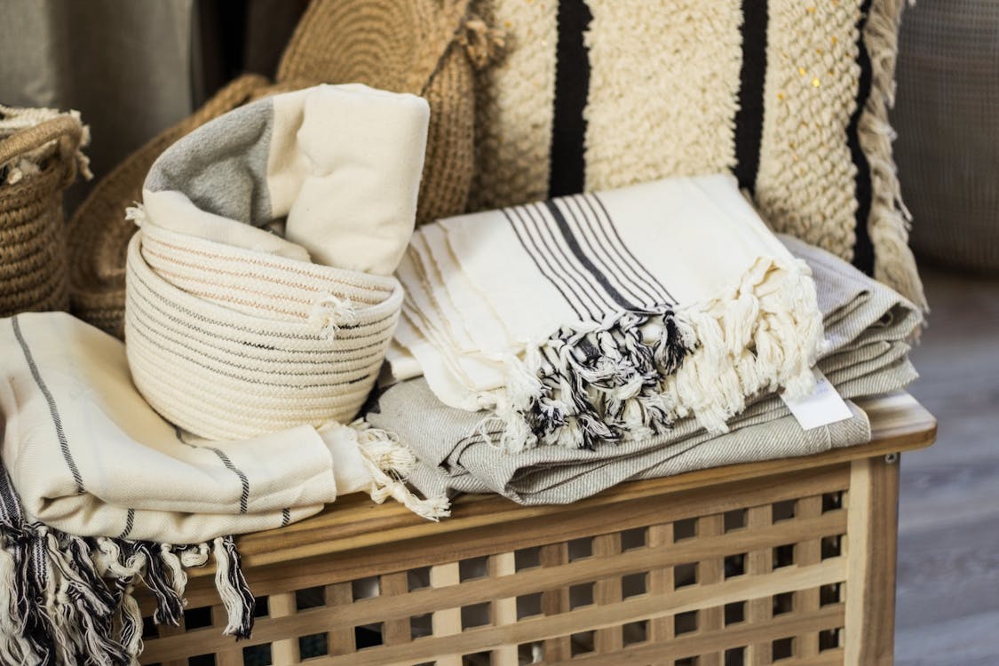 Stacked towels and plaid on wooden box