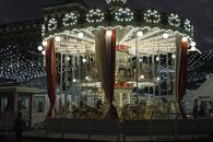 Illuminated merry go round in amusement park at night