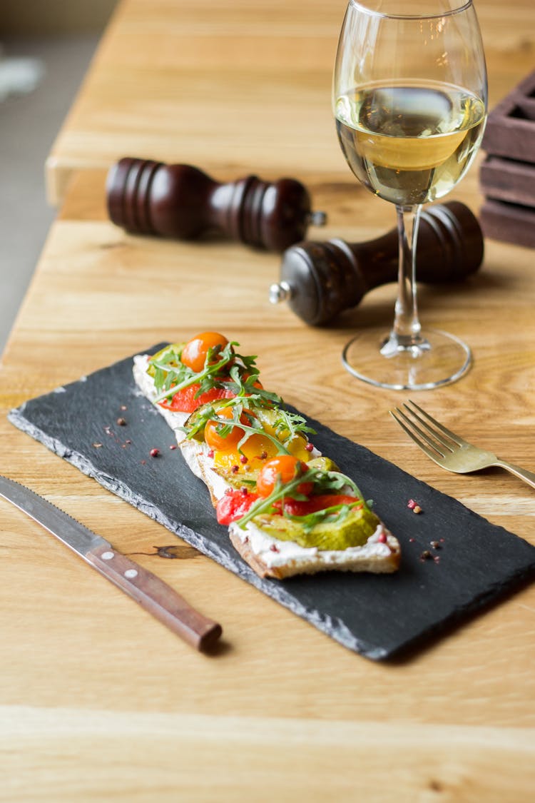 Serving Of Bruschetta And Wine On Table