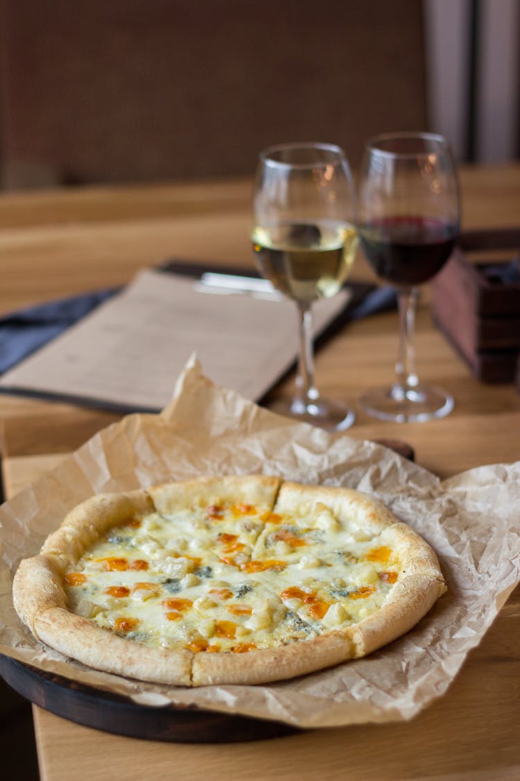 Pizza And Wine At Table In Restaurant