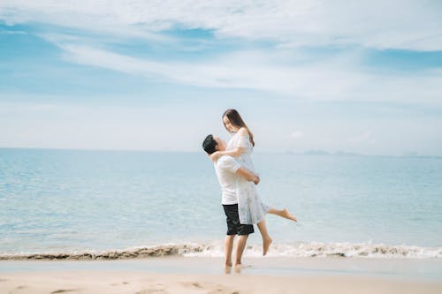 Happy couple enjoying vacation together on seashore