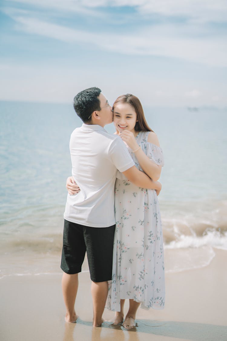 Content Asian Couple Embracing On Sea Beach During Honeymoon