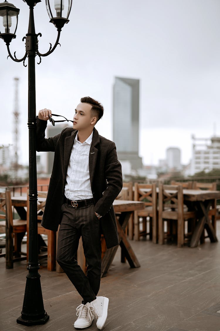 Thoughtful Well Dressed Ethnic Man On Cafeteria Terrace