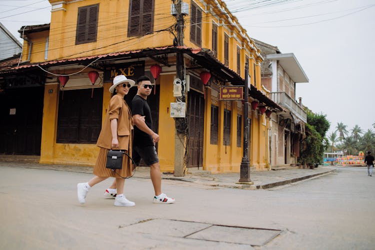 Stylish Ethnic Couple Of Travelers Walking On City Road