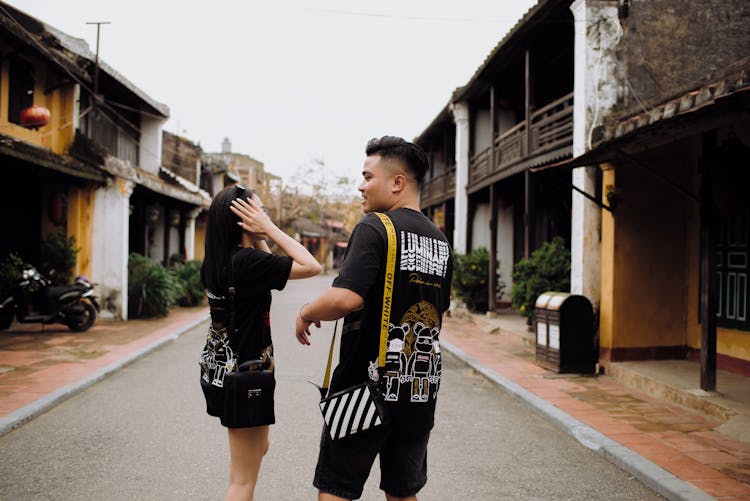 Asian Couple Of Travelers Speaking On City Road