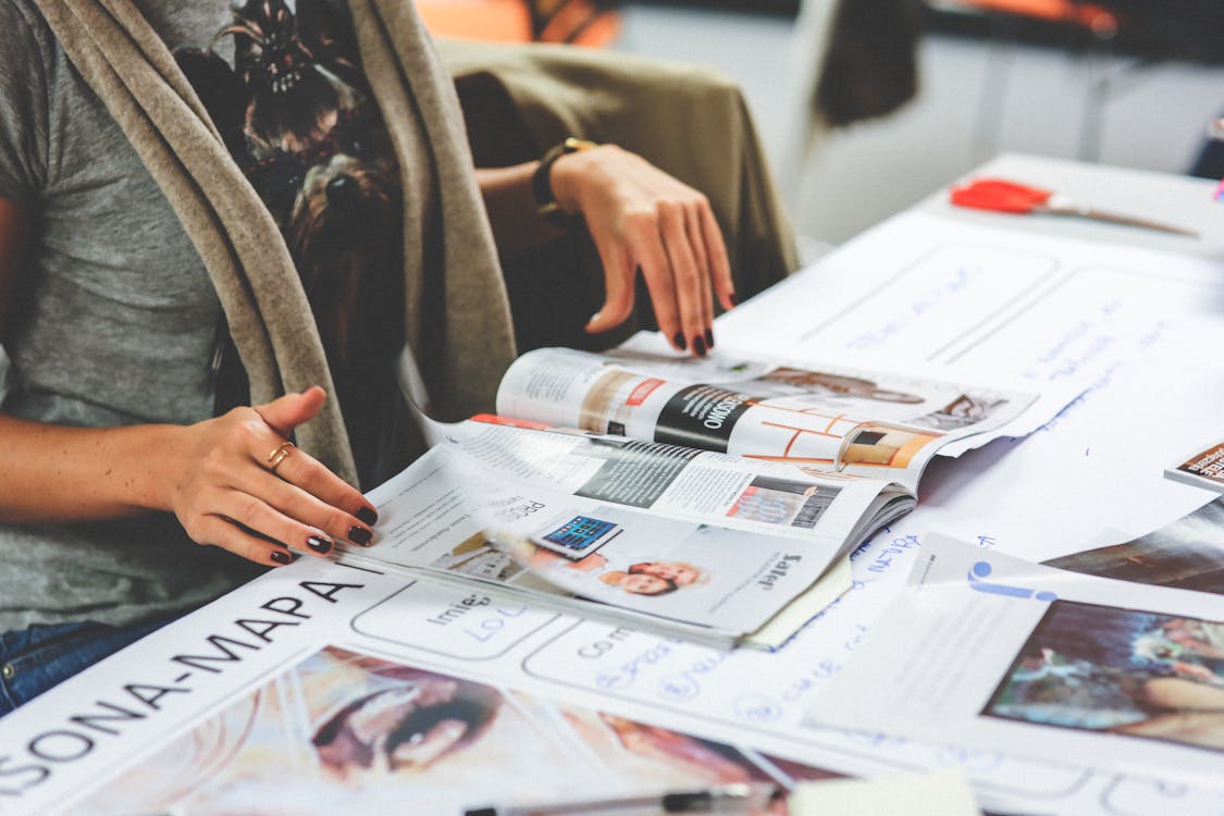 Free Person Looking through Magazines Stock Photo