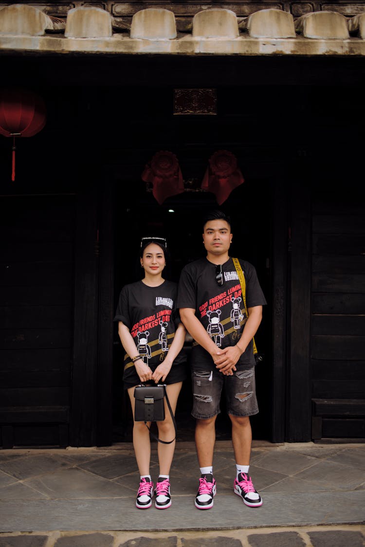 Content Asian Couple Standing Outside Typical Wooden House