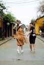 Joyful Asian couple running on rural street