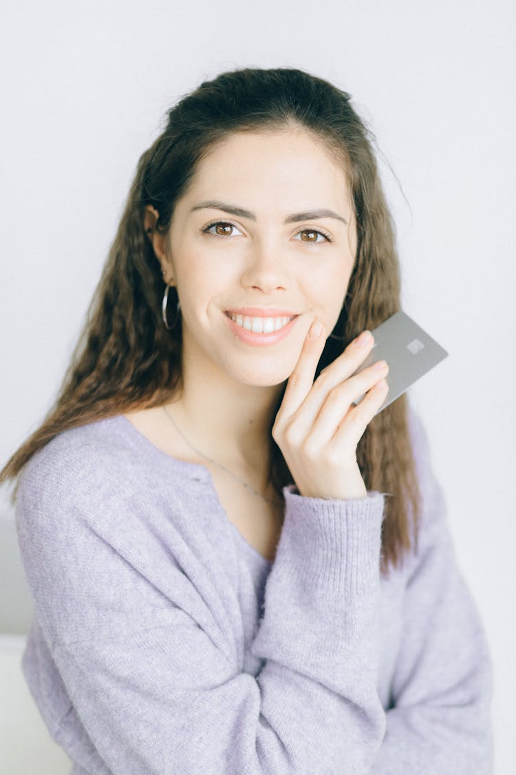 
A Smiling Woman Holding A Card