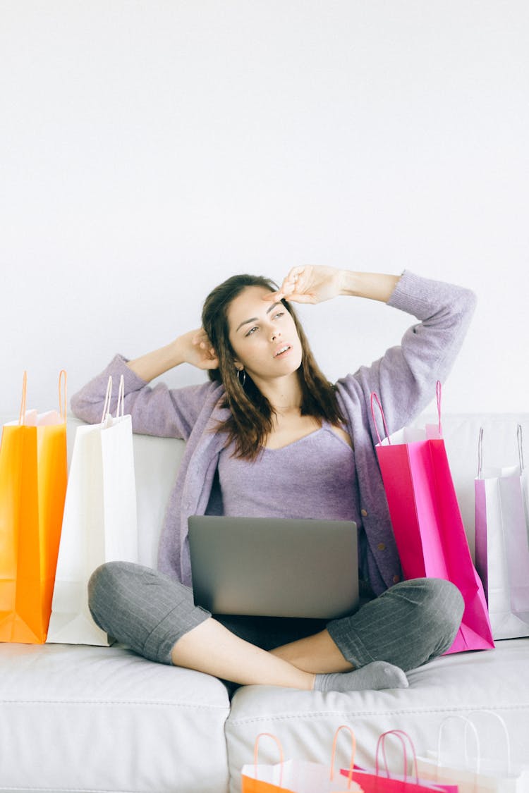 A Woman On A Couch With Paper Bags 