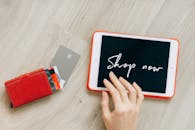 A Close-Up Shot of a Digital Tablet beside Credit Cards