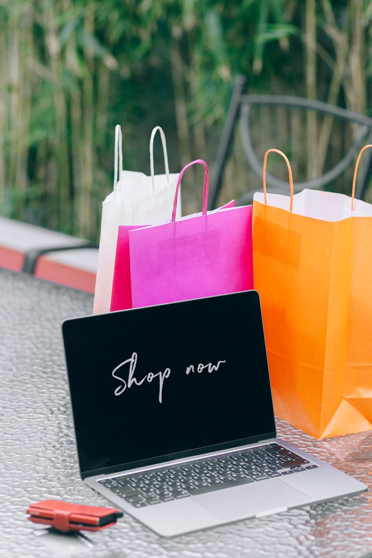 A Laptop Near Paper Bags