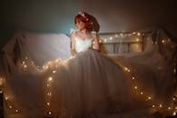 Asian bride among shiny garland at home