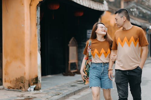 Happy ethnic couple spending time together on street