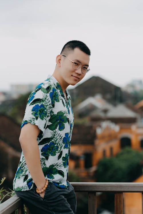 Trendy ethnic male chilling on balcony