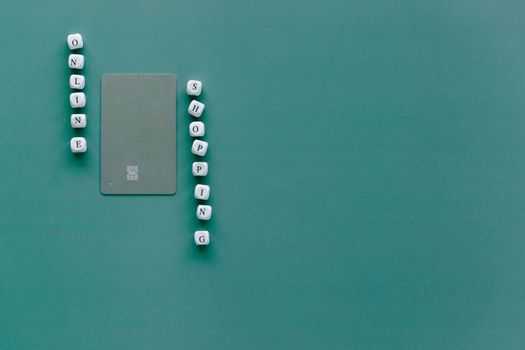 Green background with bank card and letter blocks spelling 'Online Shopping'.