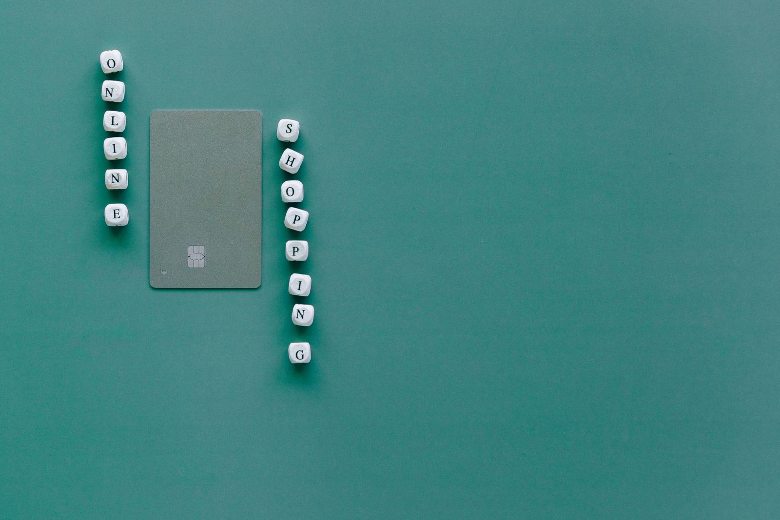 A bank card next to letter tiles spelling out online shopping