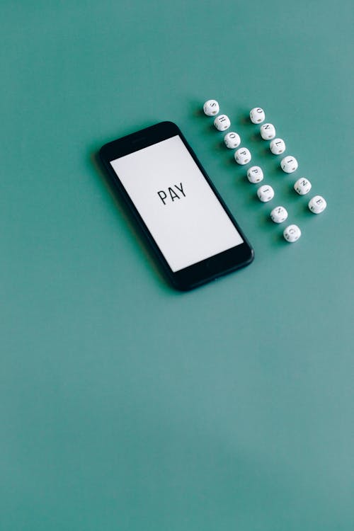 Free Black Smartphone on Green Table Stock Photo