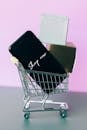 Black Smartphone on Miniature Shopping Cart