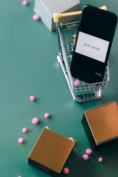 Smartphone in miniature shopping cart illustrating online shopping and ecommerce concept.