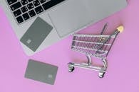 Silver Shopping Cart on Pink Surface