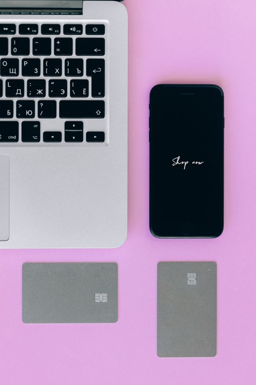 Free Flat lay of laptop, smartphone, and credit cards for online shopping on a pink background. Stock Photo