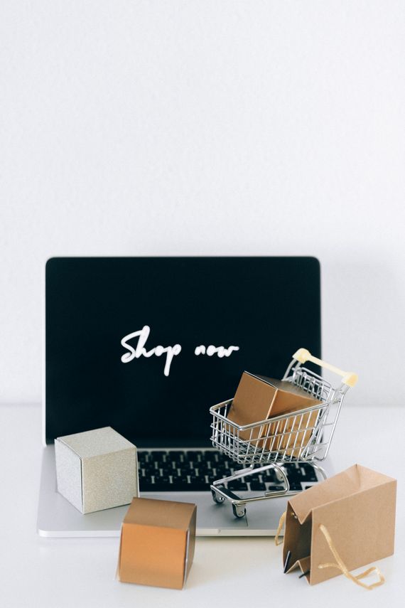 Laptop, shopping packages and ecommerce setup in a modern home