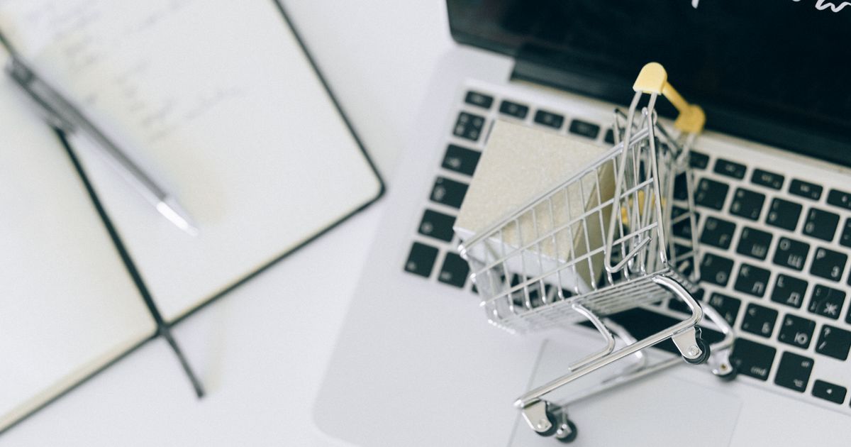 Miniature shopping cart on a laptop