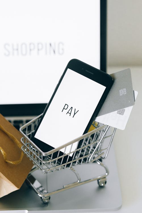 Free A Smartphone and Credit Cards in a Miniature Shopping Cart Stock Photo