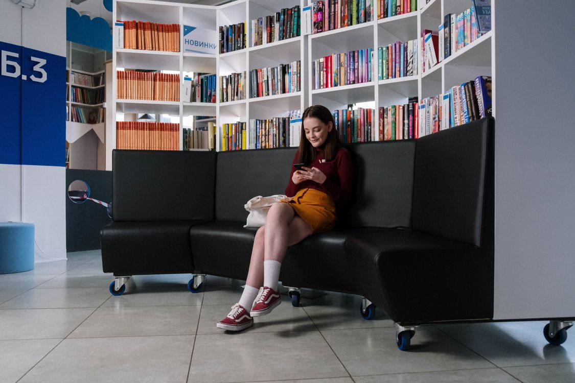 A teenage girl using her smartphone to browse social media apps