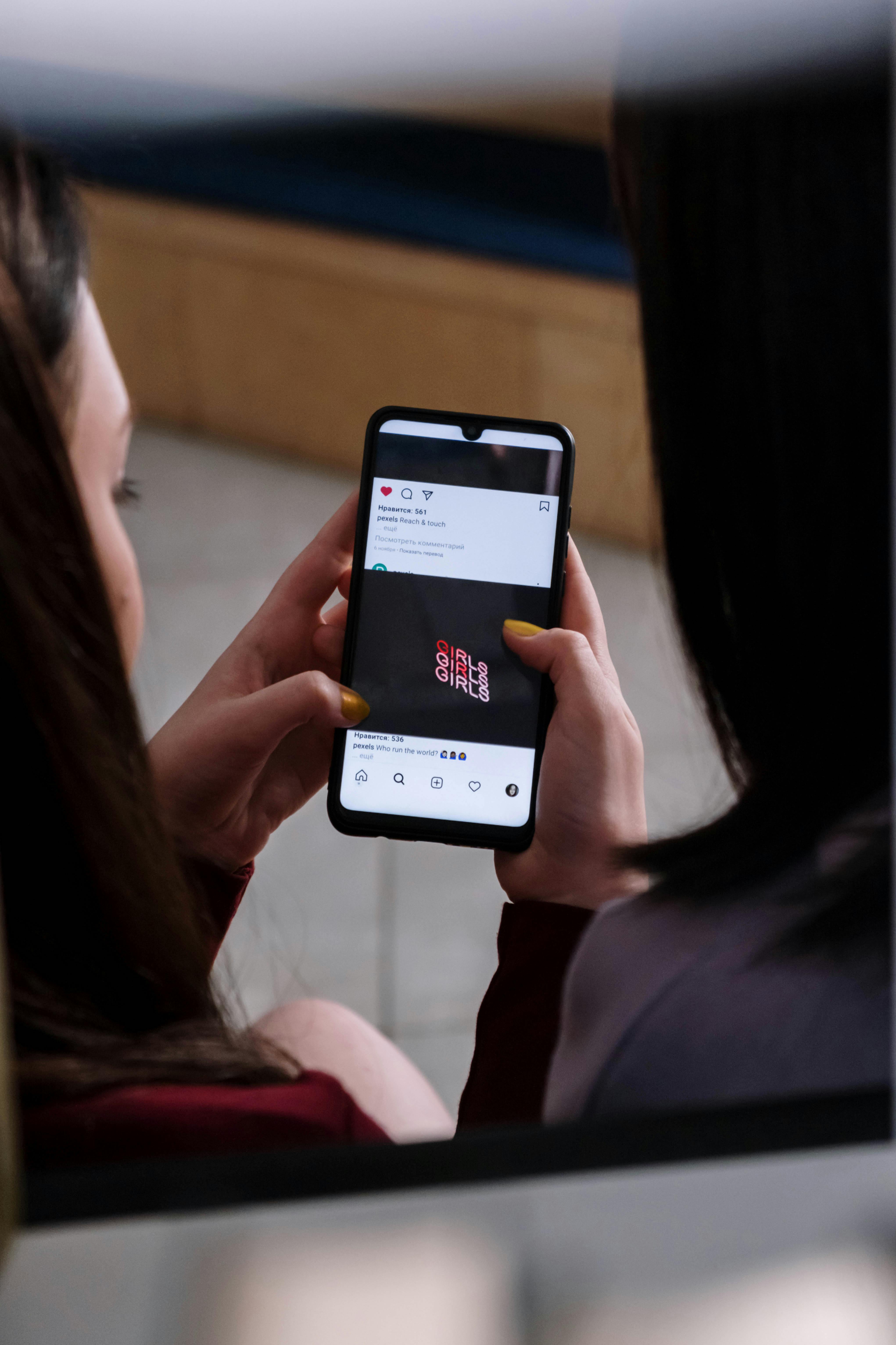 woman in black shirt holding white samsung android smartphone