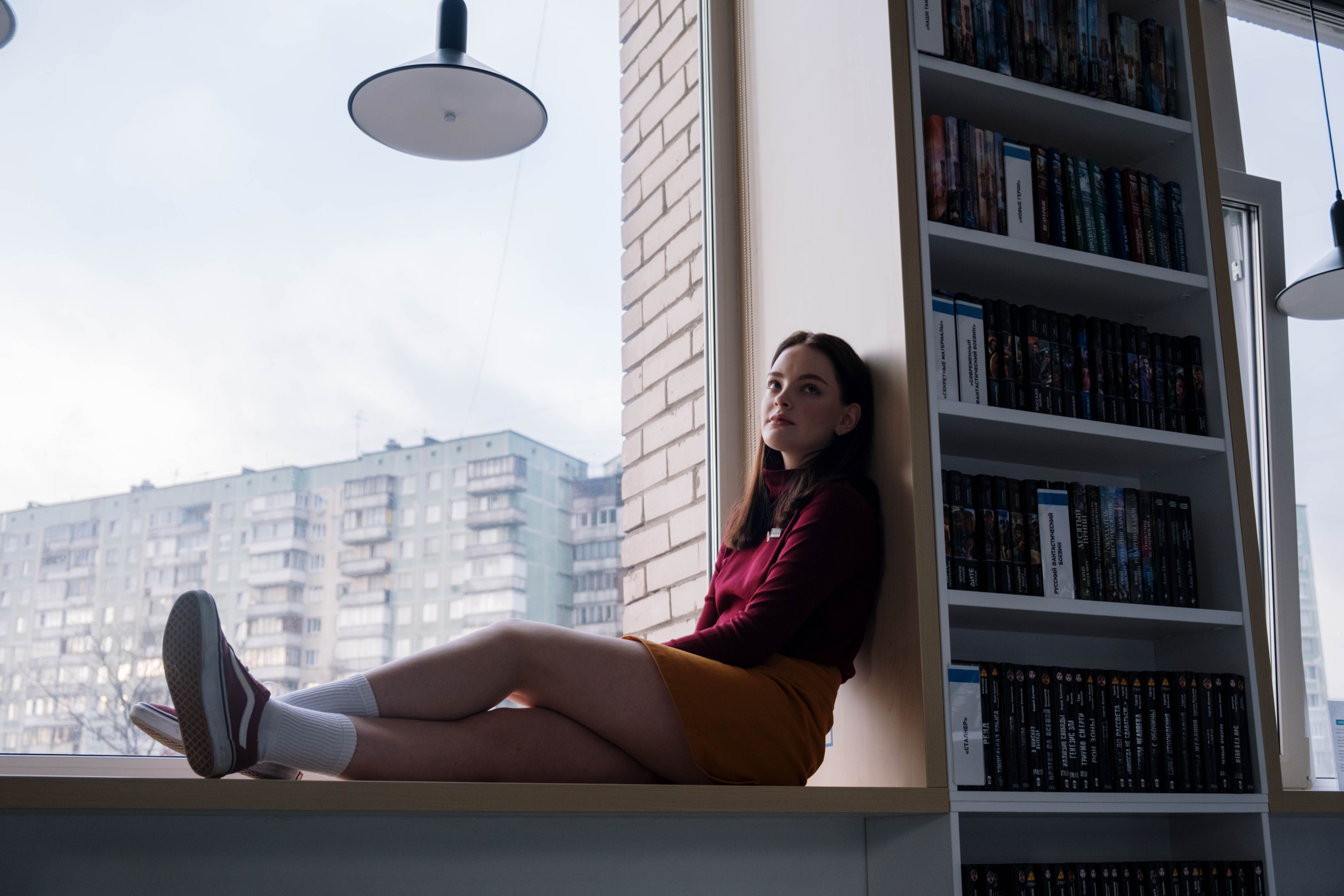 Female Teenager Sitting By The Window Of The Library · Free Stock.