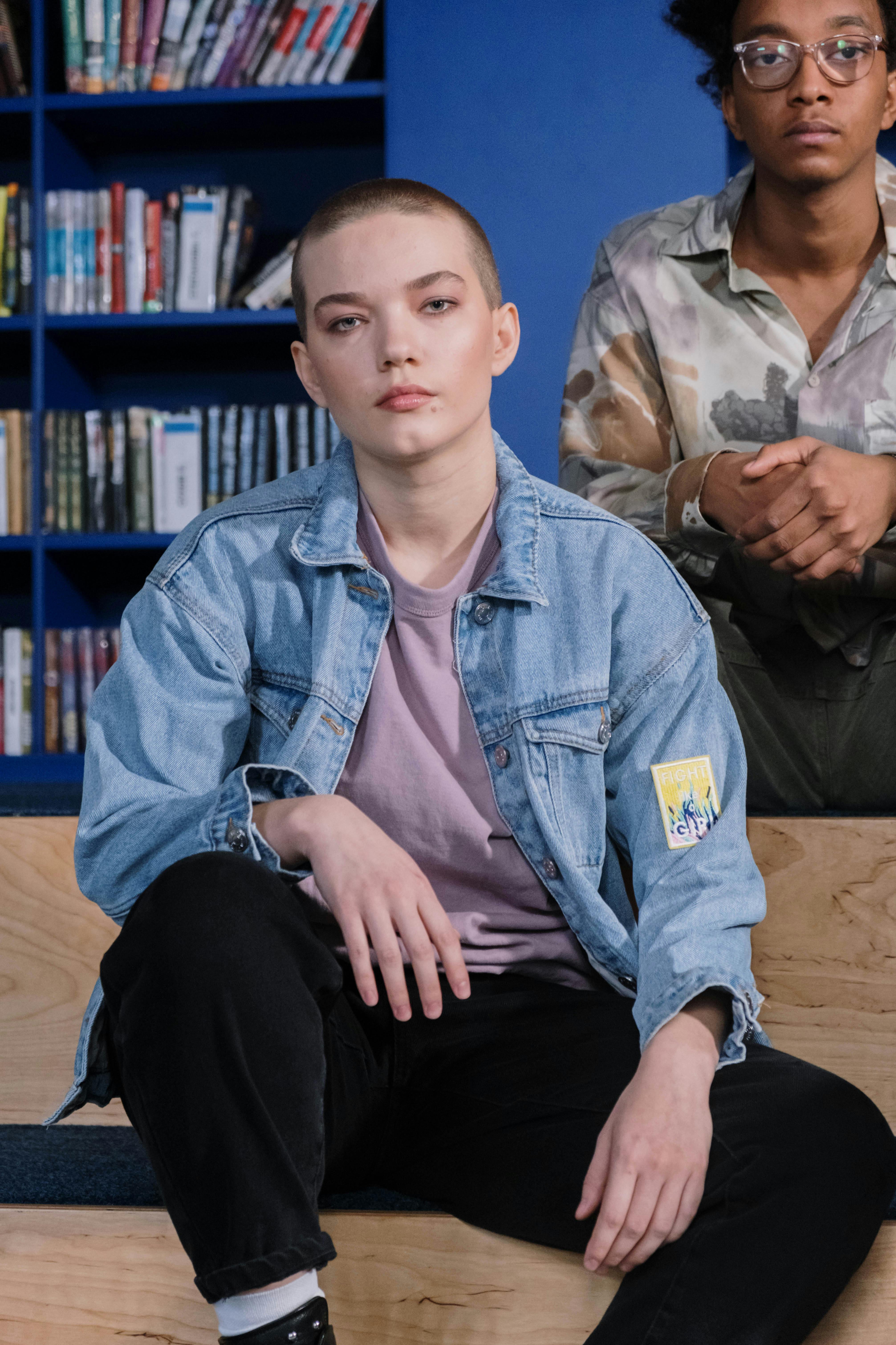 a teenager wearing a blue denim jacket