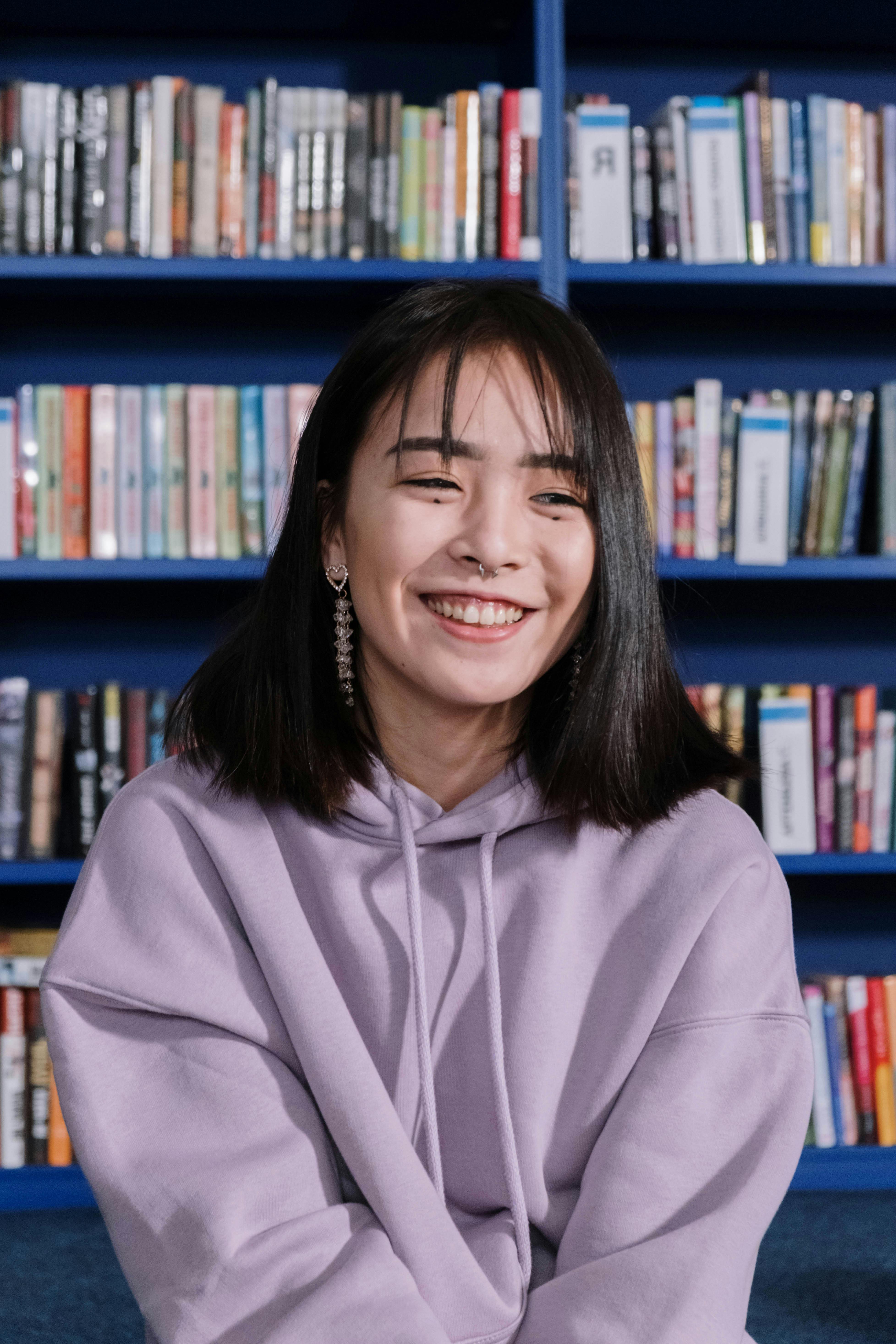 a young woman in purple hoodie smiling