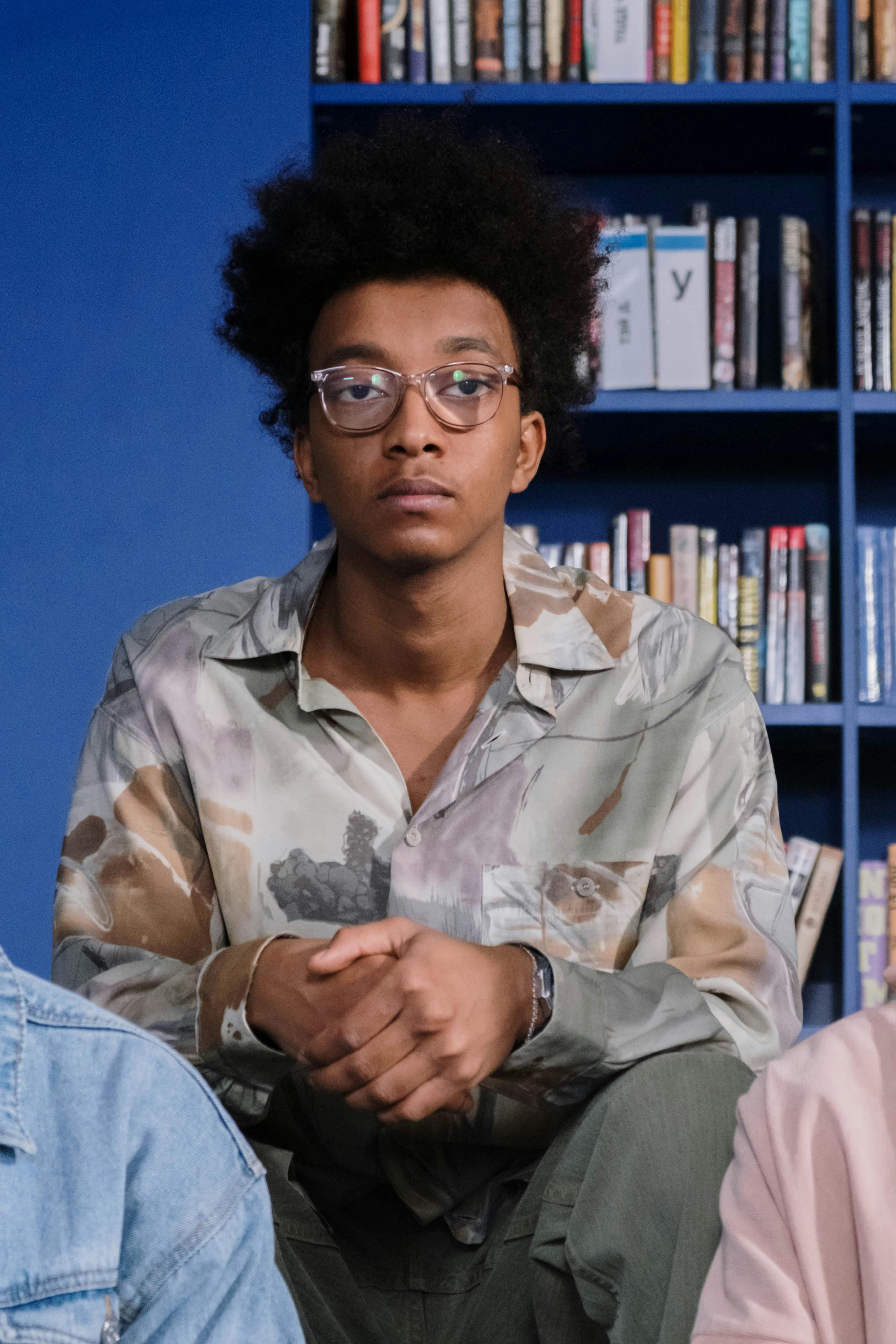 a man in printed long sleeves wearing eyeglasses