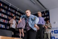 Man in Blue Denim Jacket Standing Near People