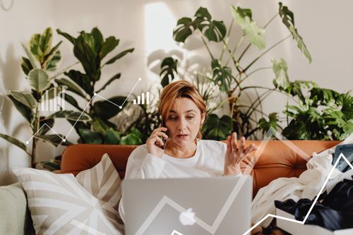 Free Woman multitasking on phone and laptop, analyzing data charts, surrounded by greenery. Stock Photo