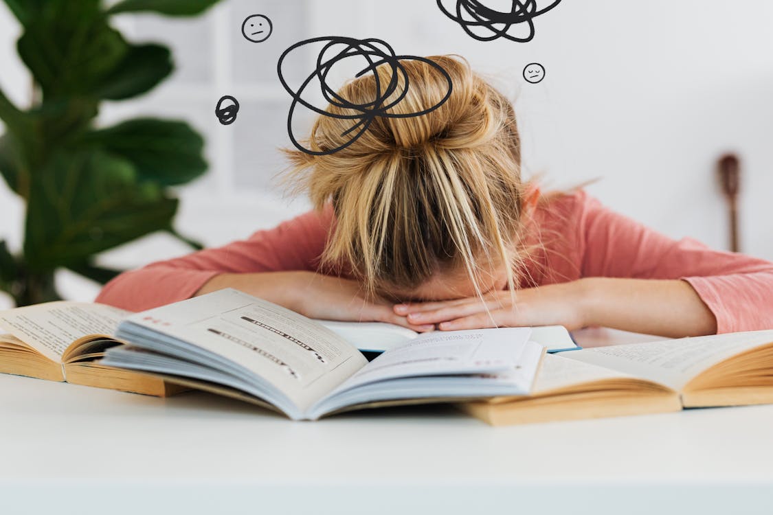 Free Woman Putting Her Head Down on the Desk Stock Photo