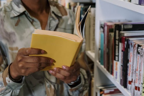 Free Close-Up Shot of a Person Holding a Book Stock Photo
