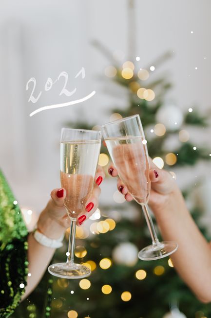 Festive toast with champagne glasses celebrating New Year 2021.