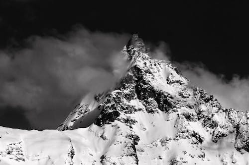 Grayscale Photo of a Snow-Covered Mountain