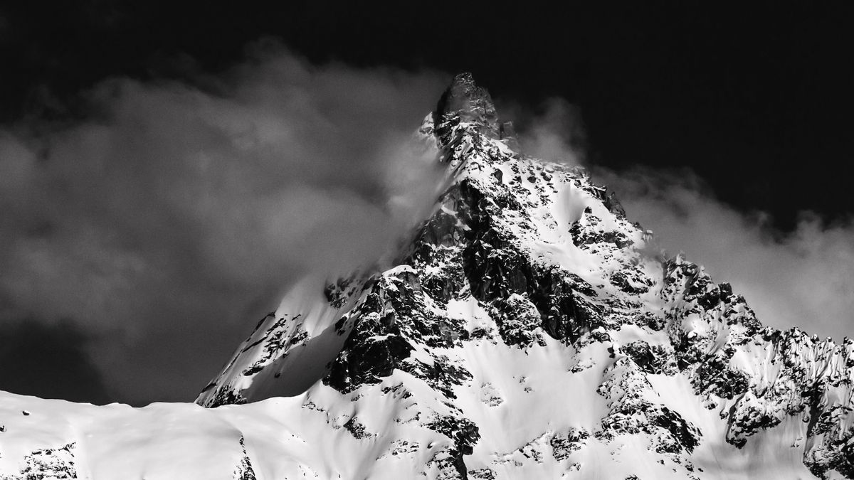 Snow peaks of the Everest range rising above a sea of cloud in clear autumn light