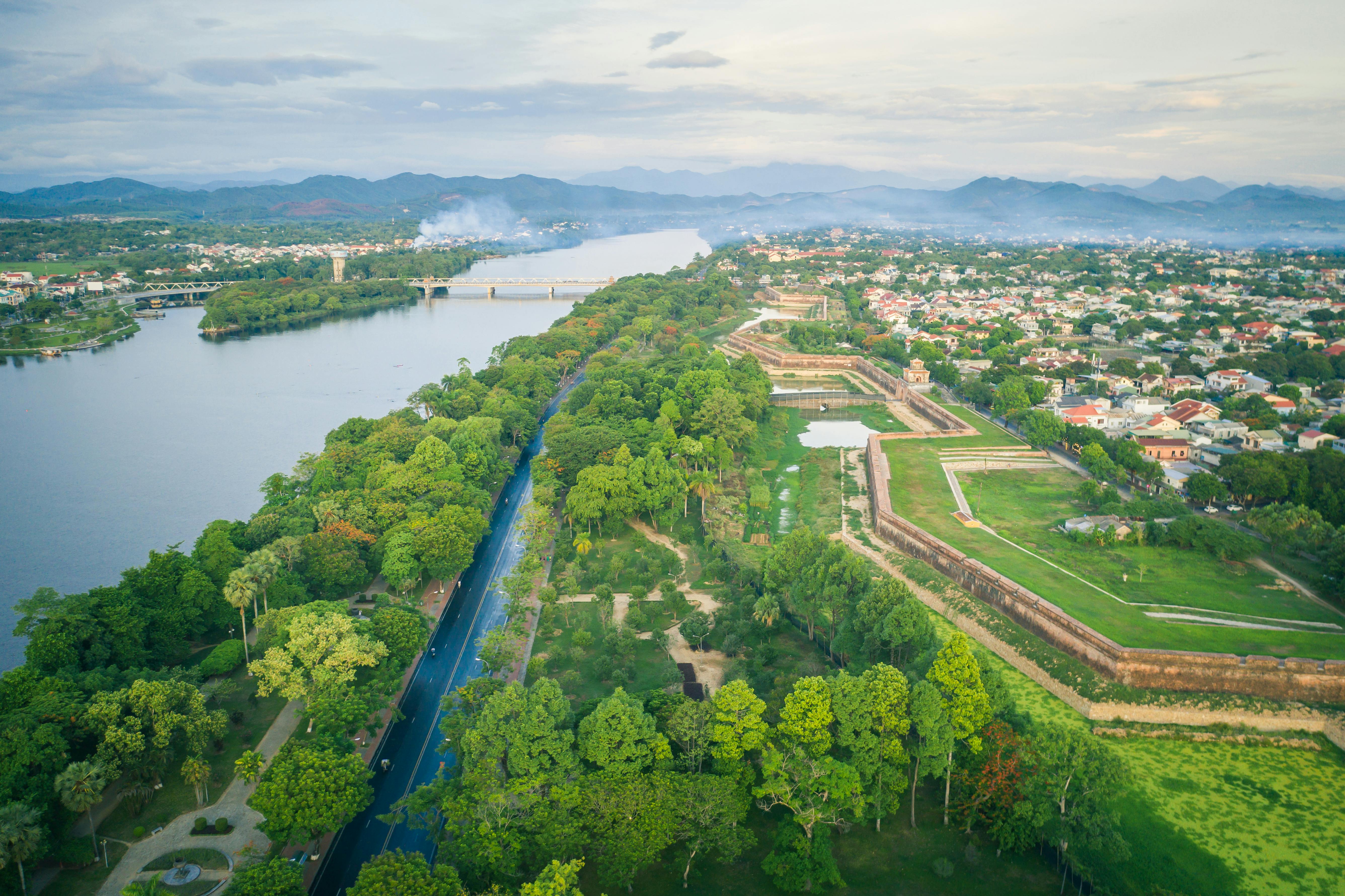 Stunning aerial view of Huế with lush greenery and scenic riverside in Vietnam.